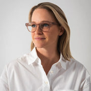 Chloé McKenzie wearing glasses and a white shirt